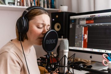 Singer recording vocals in a home studio